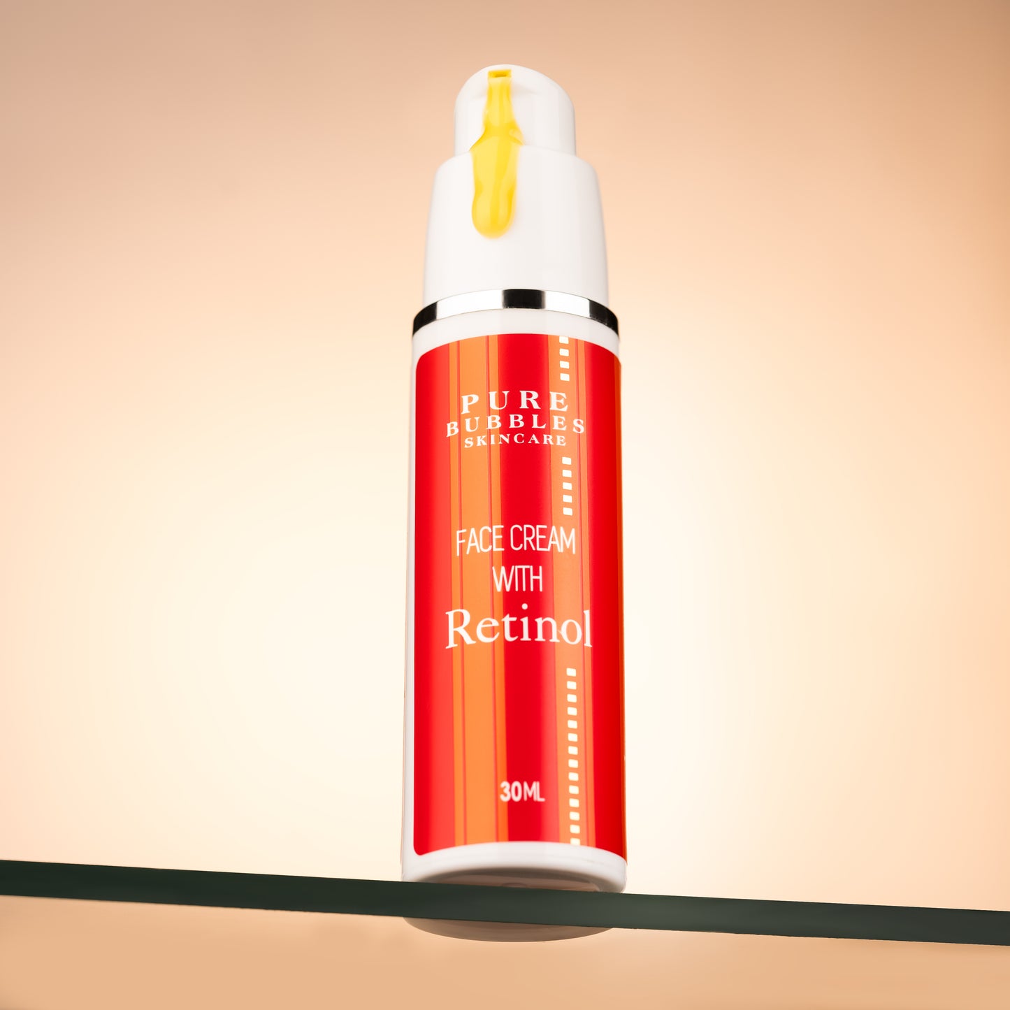 RED COLORED BOTTLE OF RETINOL FACE CREAM BY PURE BUBBLES SKINCARE WITH YELLOW CREAM