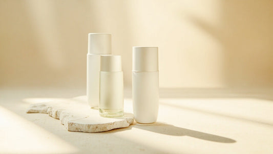 Minimalist skincare bottles with retinol and plant-based actives on stone slab, soft natural light